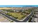 An aerial view shows a park surrounded by homes, highlighting the community's green spaces and recreational amenities at 15276 W Latham St, Goodyear, AZ 85338