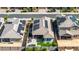 An aerial of a home showcasing its solar panels, a landscaped backyard, patio, and its placement within the neighborhood at 15276 W Latham St, Goodyear, AZ 85338