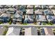 Neighborhood aerial showcasing a community with single-Gathering homes, well-maintained streets, and solar panels on many roofs at 15276 W Latham St, Goodyear, AZ 85338