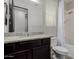 Bathroom showcasing a vanity with granite countertop, a mirror, a toilet, and a shower with tub combination at 15276 W Latham St, Goodyear, AZ 85338