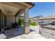 Spacious covered patio featuring a built-in grill, bar area, dining table, and travertine flooring at 15276 W Latham St, Goodyear, AZ 85338