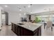 Beautiful kitchen with granite countertops, pendant lighting, stainless faucet, tile flooring and stainless appliances at 15276 W Latham St, Goodyear, AZ 85338