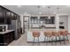 Beautiful kitchen featuring dark cabinets, granite countertops, stainless steel appliances, and walk-in pantry at 15276 W Latham St, Goodyear, AZ 85338