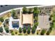 Aerial view of community park showcasing covered picnic areas, playground, basketball court and surrounding greenery at 15276 W Latham St, Goodyear, AZ 85338