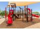 Community playground area featuring slides, climbing structures, and sun shades for safe and enjoyable outdoor play at 15276 W Latham St, Goodyear, AZ 85338