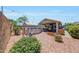 A backyard showcasing a well-maintained pool with a seating area and lush vegetation for outdoor enjoyment at 15505 N 135Th Dr, Surprise, AZ 85374