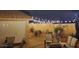 Backyard seating area with mood lighting, providing a tranquil setting for evening relaxation and entertainment at 15505 N 135Th Dr, Surprise, AZ 85374