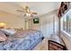 Comfortable bedroom featuring hardwood floors, a chest, a ceiling fan, and a mounted TV at 15505 N 135Th Dr, Surprise, AZ 85374