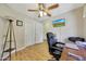 Bedroom featuring a ceiling fan, wood floor, and desk area for a comfortable and functional living space at 15505 N 135Th Dr, Surprise, AZ 85374
