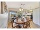 Open dining area with a view into the kitchen and sliding glass doors to backyard at 15505 N 135Th Dr, Surprise, AZ 85374