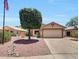 Charming one-story home boasting a well-kept lawn, mature shade tree, and an attached two-car garage at 15505 N 135Th Dr, Surprise, AZ 85374