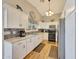 Well-lit kitchen featuring white cabinets, granite countertops, stainless steel appliances, and a mosaic backsplash at 15505 N 135Th Dr, Surprise, AZ 85374