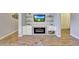 Bright living space with built-in fireplace, shelving, and stylish wood-look floors; ideal for relaxing at 15505 N 135Th Dr, Surprise, AZ 85374