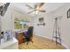 Brightly lit office with a large desk and chair, complemented by hardwood floors and natural light at 15505 N 135Th Dr, Surprise, AZ 85374