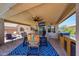 An outdoor patio area featuring comfortable seating, a ceiling fan, and an outdoor grill for entertaining at 15505 N 135Th Dr, Surprise, AZ 85374