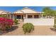 A home's backyard featuring rock landscaping and colorful flowers at 17108 N Estrella Vista Dr, Surprise, AZ 85374
