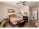 Bedroom features ceiling fan, hardwood floor, and a bed with bedside tables for convenience at 17108 N Estrella Vista Dr, Surprise, AZ 85374