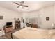 Bright bedroom boasts ceiling fan, hardwood floors, backyard view, and a comfortable bed for relaxation at 17108 N Estrella Vista Dr, Surprise, AZ 85374