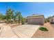 A single-story home featuring a desert landscape, tile roof, and a two-car garage in a sunny location at 17108 N Estrella Vista Dr, Surprise, AZ 85374
