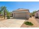 A single-story home featuring a desert landscape, tile roof, and a two-car garage in a sunny location at 17108 N Estrella Vista Dr, Surprise, AZ 85374
