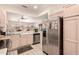 Kitchen featuring stainless steel refrigerator, tile floors, and an open floor plan to the living space at 17108 N Estrella Vista Dr, Surprise, AZ 85374