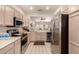 Bright kitchen features modern appliances, tile floor, and ample cabinet space for storage at 17108 N Estrella Vista Dr, Surprise, AZ 85374