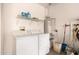 Laundry room with washer, dryer, shelving, and water heater at 17108 N Estrella Vista Dr, Surprise, AZ 85374