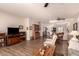 Open-concept living room with laminate floors, ceiling fans, bright natural light, and access to the kitchen at 17108 N Estrella Vista Dr, Surprise, AZ 85374