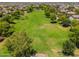 Aerial view of the lush greenbelt surrounded by homes in a well-planned community at 17652 W Fetlock Trl, Surprise, AZ 85387