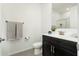 Modern bathroom featuring a dark vanity with double sinks and a framed mirror at 17652 W Fetlock Trl, Surprise, AZ 85387
