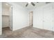 Bright bedroom with a ceiling fan and doorways leading to bathroom and closet at 17652 W Fetlock Trl, Surprise, AZ 85387