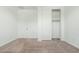 A well-lit bedroom with neutral carpet and walk-in closet access at 17652 W Fetlock Trl, Surprise, AZ 85387
