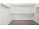 Empty walk-in closet with shelving and carpeted flooring at 17652 W Fetlock Trl, Surprise, AZ 85387
