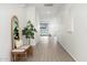 Bright entryway featuring tiled floor, bench with pillows, accent mirror and plant to welcome you home at 17652 W Fetlock Trl, Surprise, AZ 85387