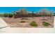 A home's front yard features desert landscaping and trees at 17652 W Fetlock Trl, Surprise, AZ 85387