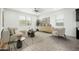 Bright, neutral living room featuring modern furnishings, wood-look floors, and plenty of natural light at 17652 W Fetlock Trl, Surprise, AZ 85387