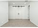 Spacious room featuring light flooring and a barn door at 17652 W Fetlock Trl, Surprise, AZ 85387