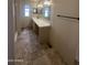 Bathroom view with vanity, countertop, sink, cabinets, mirrors, lighting and tile floor at 18026 N Cave Creek Rd # 140, Phoenix, AZ 85032