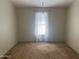 Bright bedroom featuring plush carpet and a large window at 18026 N Cave Creek Rd # 140, Phoenix, AZ 85032