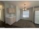 Bright dining area with neutral tones, featuring a modern chandelier and window view at 18026 N Cave Creek Rd # 140, Phoenix, AZ 85032