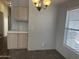 Cozy dining area with overhead light fixture, window with blinds, and breakfast bar at 18026 N Cave Creek Rd # 140, Phoenix, AZ 85032