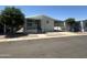 Charming home featuring a covered porch, carport, landscaped yard, and mature trees at 18026 N Cave Creek Rd # 140, Phoenix, AZ 85032