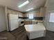 Efficient kitchen with white appliances, light wood cabinets, and a convenient breakfast bar at 18026 N Cave Creek Rd # 140, Phoenix, AZ 85032
