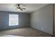 Spacious living room featuring neutral walls, carpet, and a ceiling fan at 18026 N Cave Creek Rd # 140, Phoenix, AZ 85032