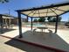 Community pool view with shaded seating area and fence on a sunny day at 18026 N Cave Creek Rd # 140, Phoenix, AZ 85032