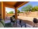 Relaxing back patio with comfortable seating, covered area, and a spacious gravel-filled backyard, perfect for outdoor entertaining at 2030 W Whisper Rock Trl, Phoenix, AZ 85085