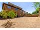 Expansive backyard with low-maintenance gravel, mature landscaping, and solar panels on the roof of the two-story home at 2030 W Whisper Rock Trl, Phoenix, AZ 85085