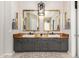 Bathroom boasts dual sinks, custom wood counters, framed mirrors, and modern lighting fixture at 2030 W Whisper Rock Trl, Phoenix, AZ 85085