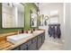 Bathroom featuring dual sinks with a wood counter, stylish mirrors, and modern fixtures at 2030 W Whisper Rock Trl, Phoenix, AZ 85085