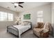 Bright bedroom with a ceiling fan, comfortable armchair, and decor at 2030 W Whisper Rock Trl, Phoenix, AZ 85085